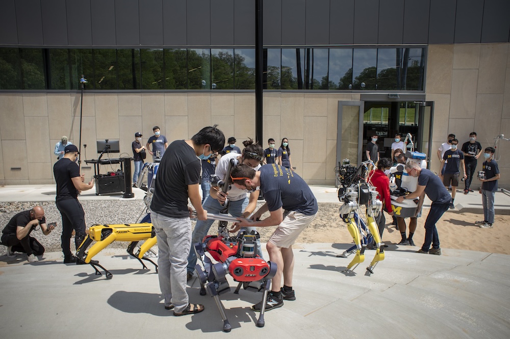 a panaply of robots and roboticists of all types gather on the robot playground